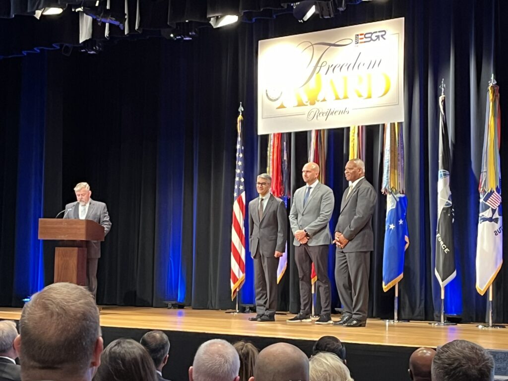 LMC Executive Director Luke Fischer receives the Freedom Award on stage at the Pentagon.