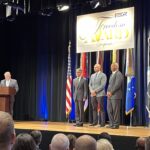 LMC Executive Director Luke Fischer receives the Freedom Award on stage at the Pentagon.