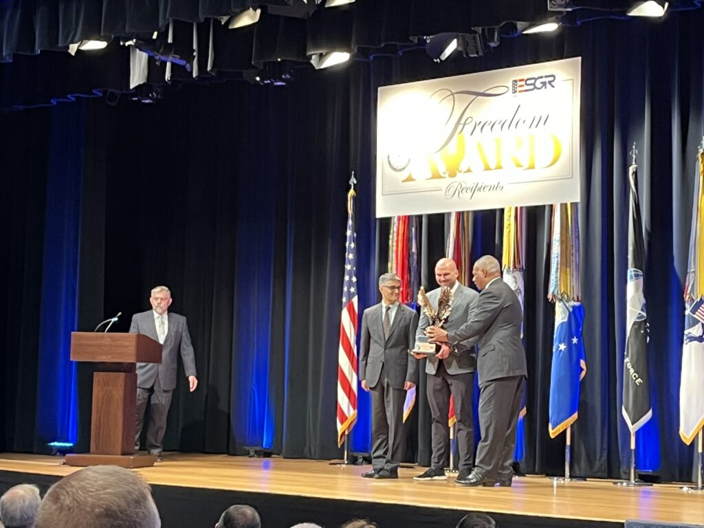 LMC Executive Director Luke Fischer receives the Freedom Award on stage at the Pentagon.