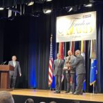 LMC Executive Director Luke Fischer receives the Freedom Award on stage at the Pentagon.