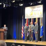 LMC Executive Director Luke Fischer receives the Freedom Award on stage at the Pentagon.