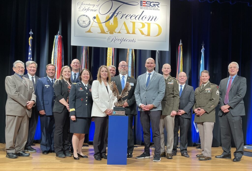 LMC Executive Director Luke Fischer receives the Freedom Award on stage at the Pentagon.