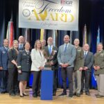 LMC Executive Director Luke Fischer receives the Freedom Award on stage at the Pentagon.