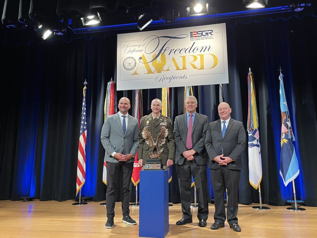 LMC Executive Director Luke Fischer receives the Freedom Award on stage at the Pentagon.