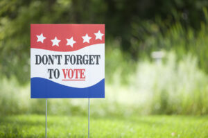 Don’t forget to vote signage in front of a grassy field