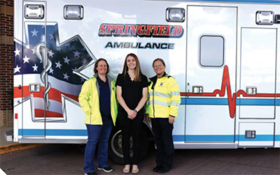 EMS technicians in front of an ambulance.